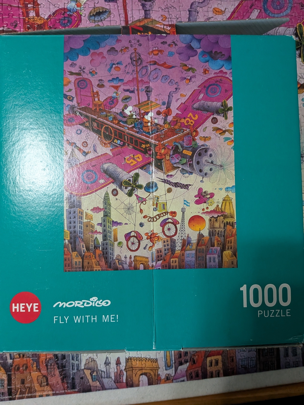 HEYE Mordillo "Fly With Me!" 1000-Piece Jigsaw Puzzle - Teal Box